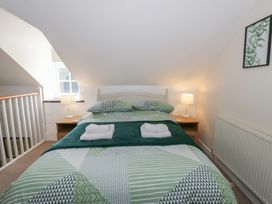 A bedroom with a bed and bedside table at Middle Cottage in Newport, Pembrokeshire