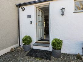 An entrance with a door and bushes at Middle Cottage Newport, Pembrokeshire