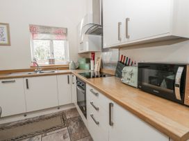 A kitchen with a sink and stove at Y Felin in Cardigan, Ceredigion