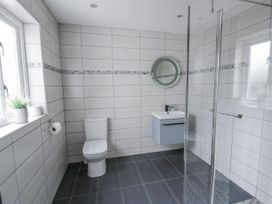 A bathroom with a sink, toilet, and shower at Y Felin in Cardigan, Ceredigion