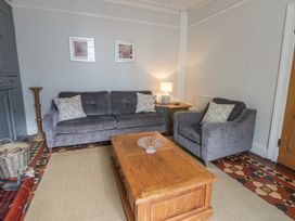 A living room with sofa and coffee table at Dewi Villa Aberarth, Ceredigion