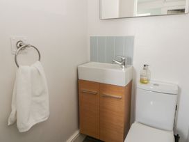 A bathroom with a sink, toilet, and towel at Dewi Villa, Aberarth, Ceredigion