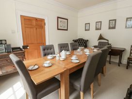 A dining room with a table set for tea at Dewi Villa in Aberarth, Ceredigion