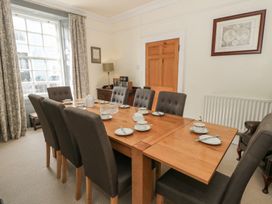 A dining room with a table set for a meal at Dewi Villa in Aberarth, Ceredigion