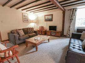 A living room with a coffee table and television at Dewi Villa in Aberarth, Ceredigion