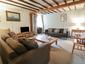 A living room with sofas and a television at Dewi Villa Aberarth, Ceredigion