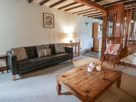 A living room with a sofa and coffee table at Dewi Villa in Aberarth, Ceredigion
