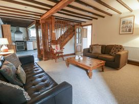 A living room with sofas and a coffee table at Dewi Villa in Aberarth, Ceredigion