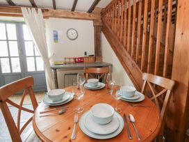 A dining room with a table set for four at Dewi Villa in Aberarth, Ceredigion