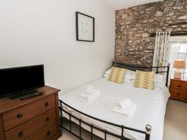 A bedroom with a bed and television at Dewi Villa in Aberarth, Ceredigion