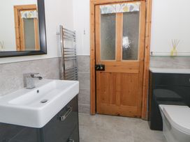 A bathroom with a wash basin and toilet at Dewi Villa in Aberarth, Ceredigion