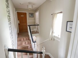 A staircase leading to a hallway at Dewi Villa in Aberarth, Ceredigion
