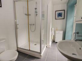 A bathroom with a shower and sink at Dewi Villa in Aberarth, Ceredigion