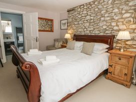 A bedroom with a bed and bedside table at Dewi Villa, Aberarth, Ceredigion