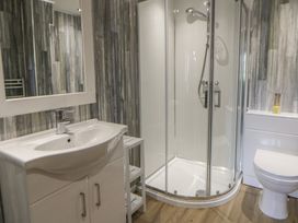A bathroom with a shower and a sink at Dewi Villa Aberarth, Ceredigion