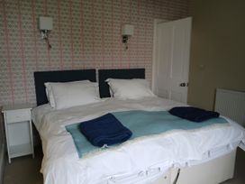 A bedroom with a bed and nightstand at Lyndale Newport, Pembrokeshire