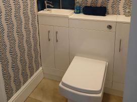 A bathroom with a toilet and sink at Lyndale in Newport, Pembrokeshire