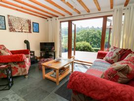 A living room with sofas and a television at Dan Castell Cottage, Llandeilo, Carmarthenshire
