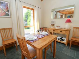 A dining room with a table and chairs at Dan Castell Cottage in Llandeilo, Carmarthenshire