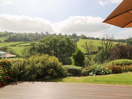 A garden view with green hills and trees at Dan Castell Cottage in Llandeilo, Carmarthenshire