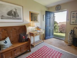 An entrance hall with a bench and table at Dolwylan in Newport, Pembrokeshire