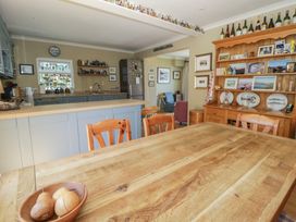 A kitchen with a dining table and chairs at Dolwylan, Newport, Pembrokeshire