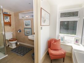 A bathroom with a shower, toilet, and sink at Dolwylan in Newport, Pembrokeshire