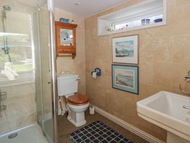 A bathroom with shower, toilet, and sink at Dolwylan in Newport, Pembrokeshire