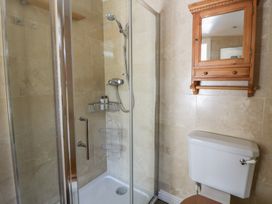 A bathroom with a shower and toilet at Dolwylan Newport, Pembrokeshire