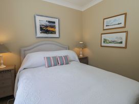 A bedroom with a bed and artwork at Dolwylan Newport, Pembrokeshire