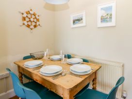 A dining room with a table set for dinner at Delyn Aur, Tresaith, Ceredigion