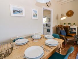 A dining room with a table set for a meal at Delyn Aur Tresaith, Ceredigion