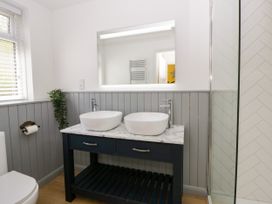 A bathroom with a sink and shower at Delyn Aur in Tresaith, Ceredigion