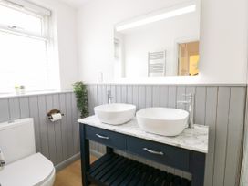 A bathroom with sink and toilet at Delyn Aur Tresaith, Ceredigion