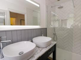 A bathroom with two basins and a shower at Delyn Aur Tresaith, Ceredigion