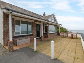 An outdoor area with a table and chairs at Delyn Aur in Tresaith, Ceredigion