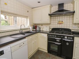 A kitchen with a stove and sink at Little Barn Cottage in Dinas Cross, Pembrokeshire