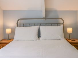 A bedroom with a bed and bedside lamps at Little Barn Cottage, Dinas Cross, Pembrokeshire
