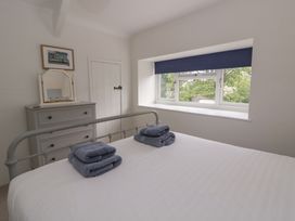 A bedroom with a bed and dresser at Little Barn Cottage Dinas Cross Pembrokeshire