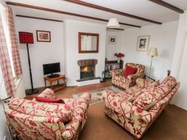 A living room with furniture and a fireplace at Ty Canol in Mathry, Pembrokeshire