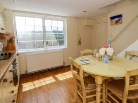 A kitchen with a dining table and chairs at Beach Retreat in Aberporth