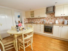 A kitchen with a table and chairs at Beach Retreat in Aberporth