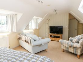 A living room with a sofa and television at Beach Retreat in Aberporth