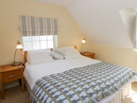 A bedroom with a double bed and bedside table at Beach Retreat in Aberporth