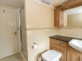A bathroom with a shower and sink at Beach Retreat in Aberporth