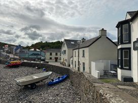An outdoor area with boats and houses at Beach Cottage in Little Haven, Pembrokeshire