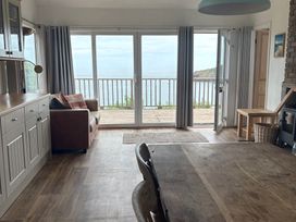 A living room with a view of the sea at Beach Cove in Freshwater East, Pembrokeshire