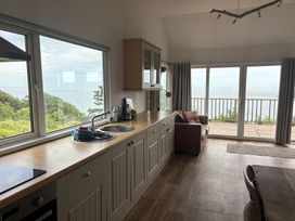 A kitchen with a view of the sea at Beach Cove, Freshwater East, Pembrokeshire