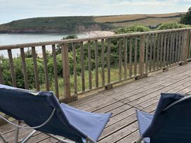 An outdoor area with chairs overlooking the sea at Beach Cove, Freshwater East, Pembrokeshire