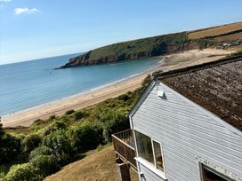 View of a beach and ocean near a house at Beach Cove, Freshwater East, Pembrokeshire
